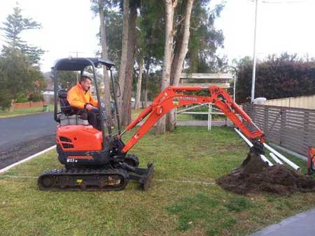 excavator laying pipes